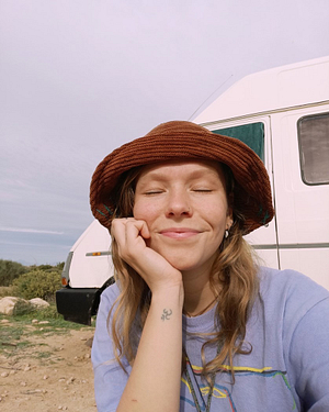 Fien in front of Camper Travelling in a Van